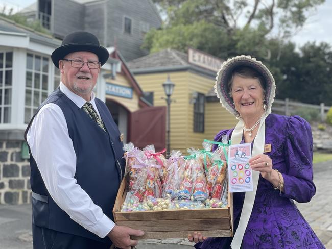 Gerard the school teacher and Lorraine a volunteer at Warrnambool Flagstaff Hill holding activity prizes for the Easter egg search activities over the long weekend.