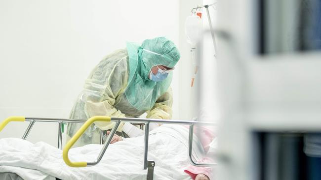 A nurse in protective clothes takes a blood sample of a patient potentially infected by the novel coronavirus Covid-19 at the Turku University Hospital Tyks in Finland.