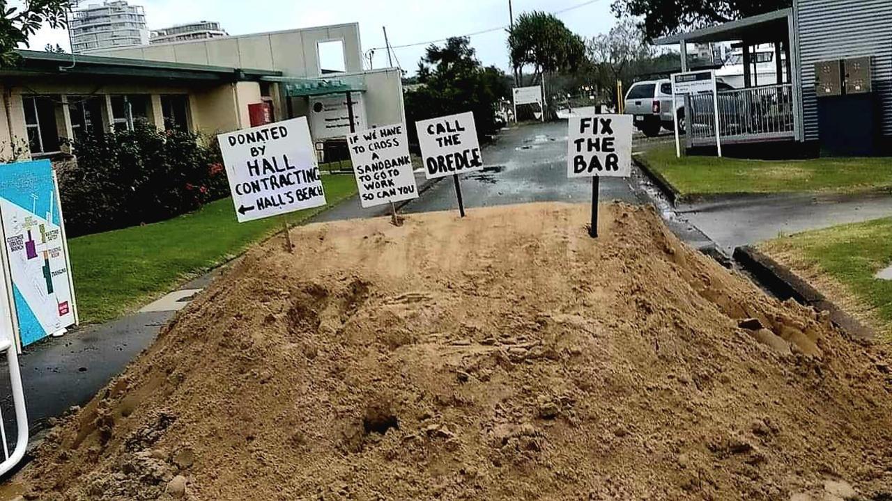 Fishers dumped sand and signs at the entrance to the Maritime Safety Queensland office at Mooloolaba.