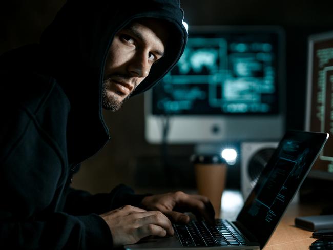 Hacker working on computer. Cyber crime concept. Scam, scammer generic.