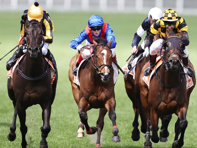 MELBOURNE. 09/10/2021. Horse Racing. Caulfield Guineas day at Caulfield racecourse, Melbourne. Race 6. The Might And Power.  Probabeel ridden by Brett Preeble (black and gold checkered cap) beats home Nonconformist ridden by Jordan Childs (yellow cap) with favourite Zaaki ridden by Craig Williams (blue cap) a disappointing 3rd  . Photo by Michael Klein