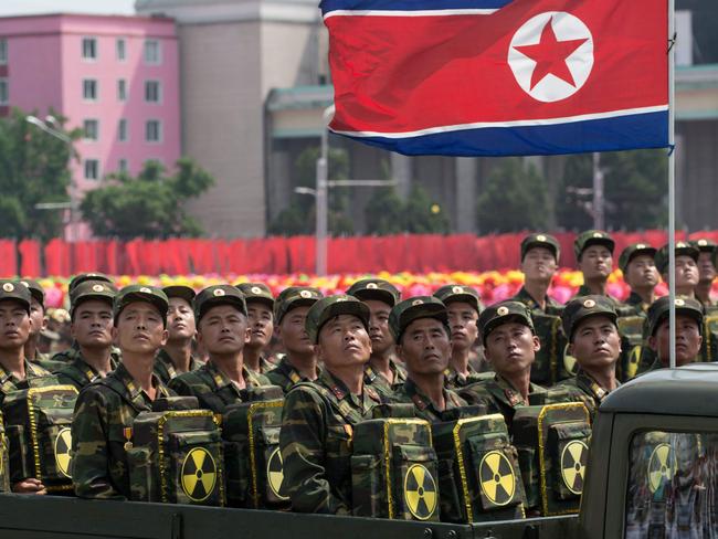 Korean People's Army (KPA) soldiers carrying packs marked with a radioactive symbol take part in a military parade in Pyongyang. Picture: AFP