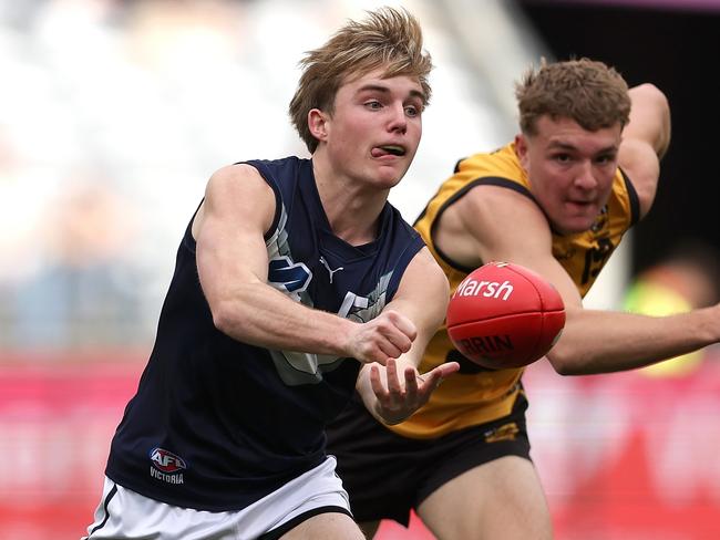 PERTH, AUSTRALIA - JUNE 23: Tom Gross of Victoria Metro handballs during the Marsh AFL National Championships match between U18 Boys Western Australia and Victoria Metro at Optus Stadium on June 23, 2024 in Perth, Australia. (Photo by Paul Kane/AFL Photos/via Getty Images)