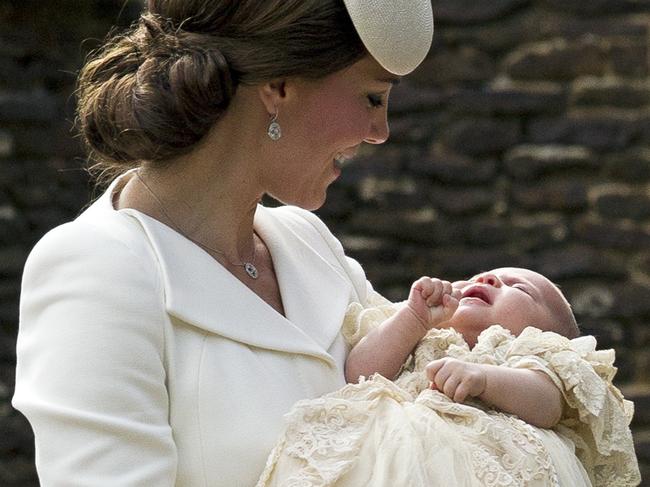 Britain’s Kate the Duchess of Cambridge carries Princess Charlotte after taking her out of a pram as they arrive for Charlotte’s Christening at St. Mary Magdalene Church in Sandringham, England, Sunday, July 5, 2015. Picture: AP