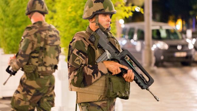 French soldiers stand guard by the sealed off area following the attack. Picture: AP