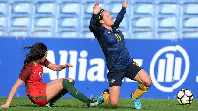 Lisa De Vanna goes down under a heavy tackle.