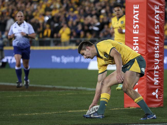 Australia's Jack Maddocks grounds the ball to score a try against the All Blacks. Picture: AP