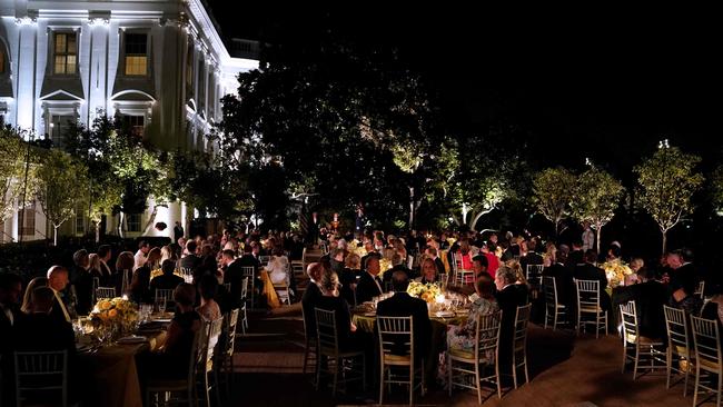 Guests dine in the Rose Garden of the White House.