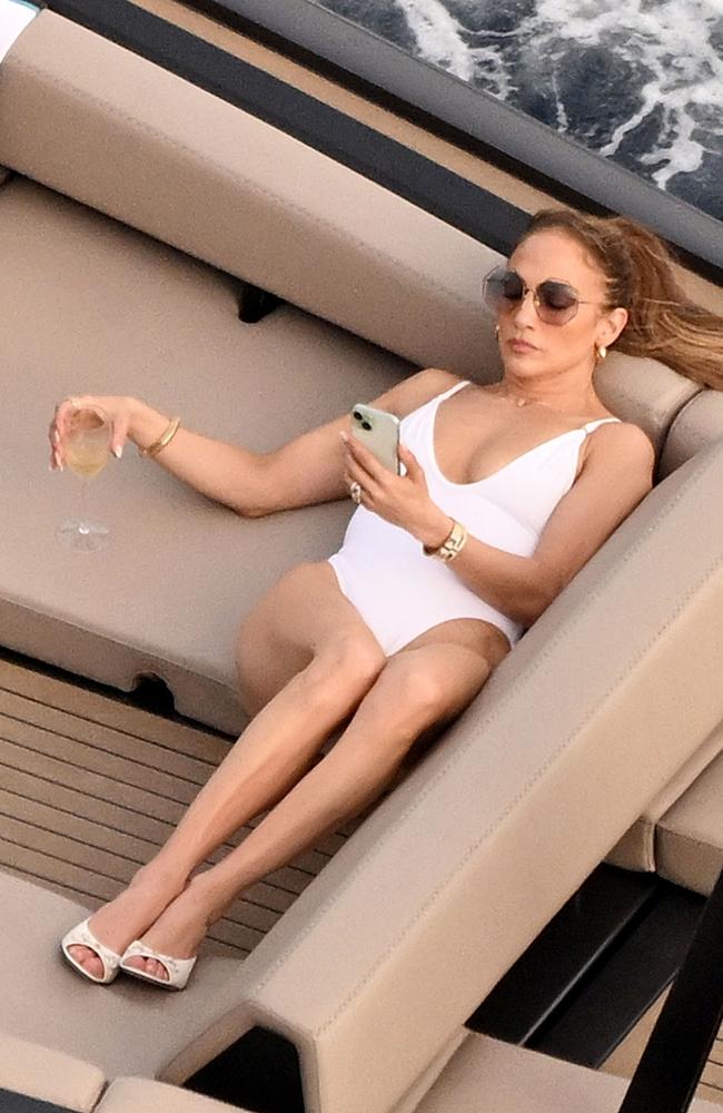 Singer and actress Jennifer Lopez rocks a white swimsuit as she enjoys the Italian sunshine. Picture: COBRA TEAM / BACKGRID