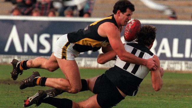 Glenelg Hall of Fame inductee Allan Bartlett tackles Port Adelaide great Scott Hodges.