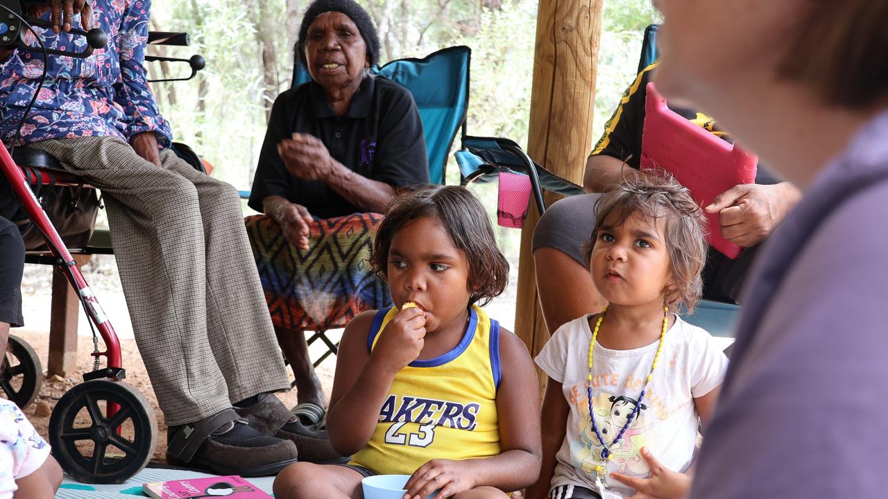 Children are read to by Elder Felicity Hayes near Trephina Gorge. Picture: Riley Walter