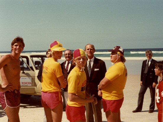 His Royal Highness Prince Philip, Duke of Edinburgh with Surf Lifesavers on Surfers Paradise Beach, Gold Coast, Queensland, October 1982. Picture: Pauline Holley (Image courtesy of the City of Gold Coast Local Studies Library)