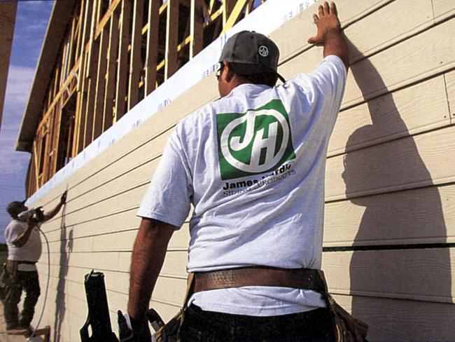 Construction worker wearing James Hardie logo top while building house Aug 2000.