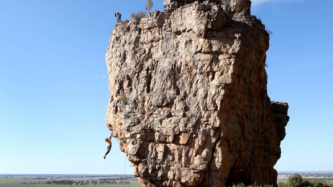 John Fischer climbs Castle Crag on Mount Arapiles in western Victoria as Nick Perndt waits at the summit. Picture: David Geraghty