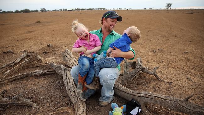 **** WARNING **** STRICT EMBARGO UNTIL JULY 1ST - MUST SPEAK TO JEFF DARMANIN BEFORE PUBLISHING - SUNDAY TELEGRAPH - Images of drought ravaged north west NSW as the area battles through one of the worst dry spells in history. Peter Holcombe, 32, Eve Holcombe, 3, Finn Holcombe, 2 pictured on their 6,900 hectares near Walgett. Pic, Sam Ruttyn