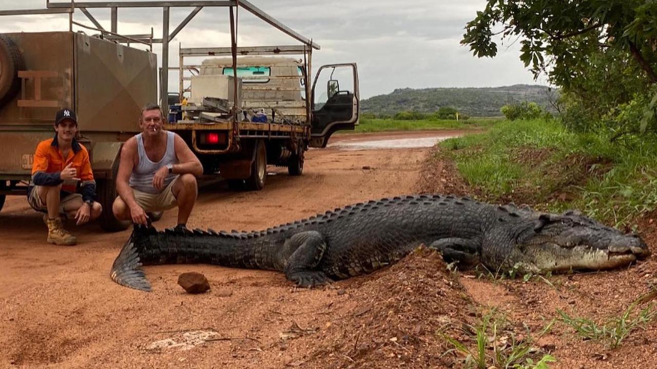 The workers managed to get a photo with the croc. Picture: Facebook/ Kane Marcus