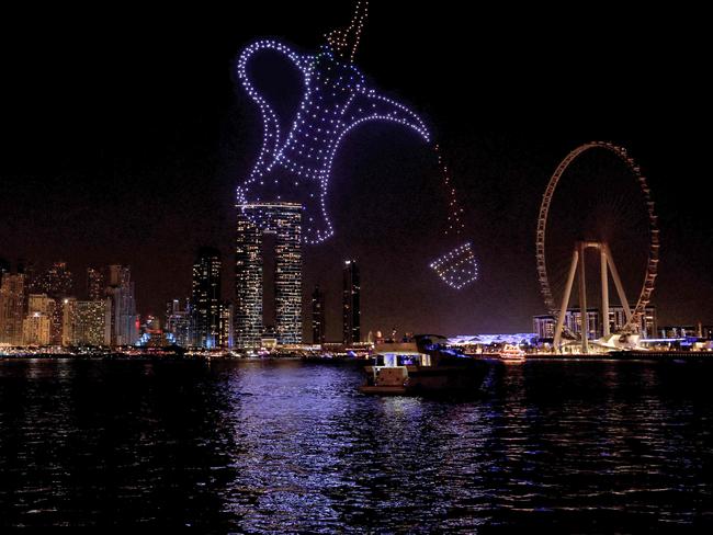 Drone lights and the Dubai Eye illuminate the sky in the shape of a Dallah (traditional coffee pot) over the Dubai waterfront. Picture: AFP