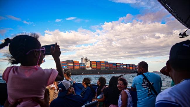 Tourists look at a cargo ship waiting to enter the Panama Canal in January. Picture: AFP