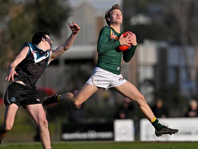 Laurimar’s Joel Lawson (left) takes on Old Eltham Collegians’ Bradley Johnstone. Picture: Andy Brownbill