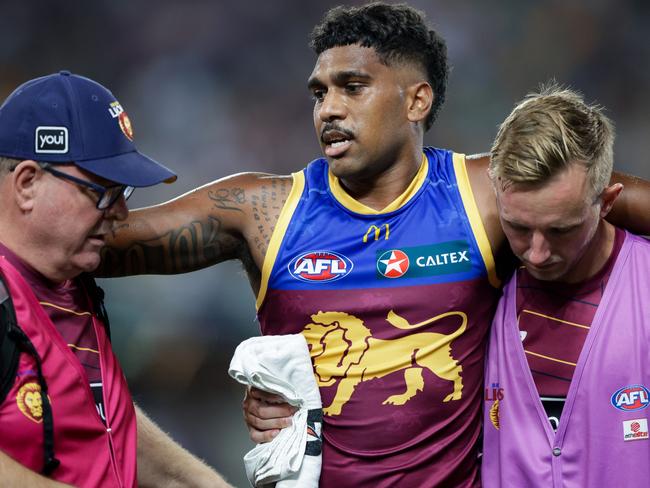 BRISBANE, AUSTRALIA - MARCH 08: Keidean Coleman of the Lions is assisted by trainers during the 2024 AFL Opening Round match between the Brisbane Lions and the Carlton Blues at The Gabba on March 08, 2024 in Brisbane, Australia. (Photo by Russell Freeman/AFL Photos via Getty Images)