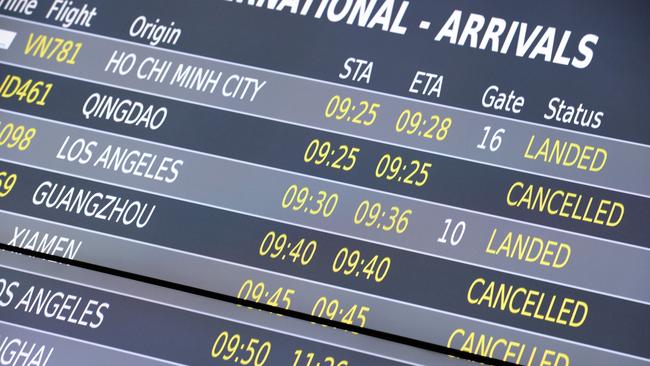 Melbourne Airport's arrivals board displays cancelled flights from China due to coronavirus. Picture: Andrew Henshaw