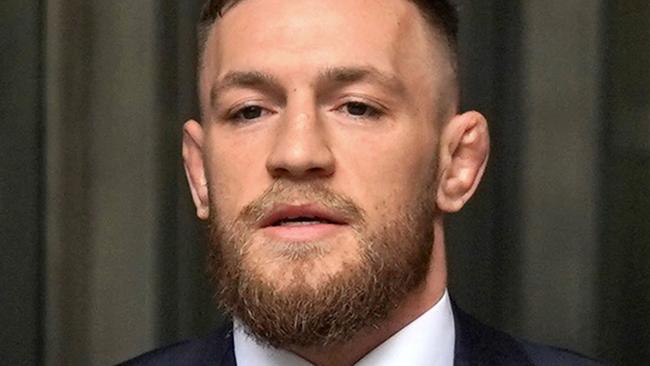 (FILES) Irish mixed martial arts fighter Conor McGregor (C) arrives to talk to the press after he pleaded guilty to a single violation of disorderly conduct in Brooklyn Criminal Court, on July 26, 2018. A woman on November 22, 2024 won civil court damages claim against mixed martial arts (MMA) fighter Conor McGregor over her allegation that he raped her in a Dublin hotel in 2018. (Photo by TIMOTHY A. CLARY / AFP)