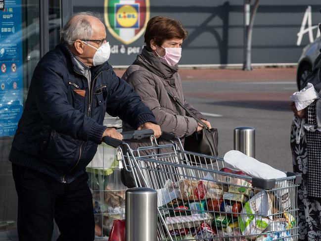 Shoppers after being given 10 minutes to access the supermarket for essentials in Casalpusterlengo, southwest Milan. Picture: Emanuele Cremaschi/Getty