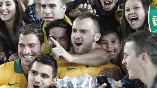 Fans celebrate with Australia's Ivan Franjic, center, after winning the AFC Asian Cup final soccer match between South Korea and Australia in Sydney, Australia, Saturday, Jan. 31, 2015. (AP Photo/Quentin Jones)