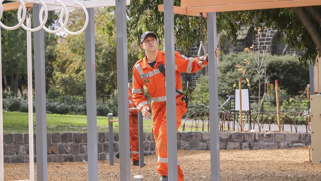 An SES member checks playground equipment on Sunday. Picture: Wayne Taylor