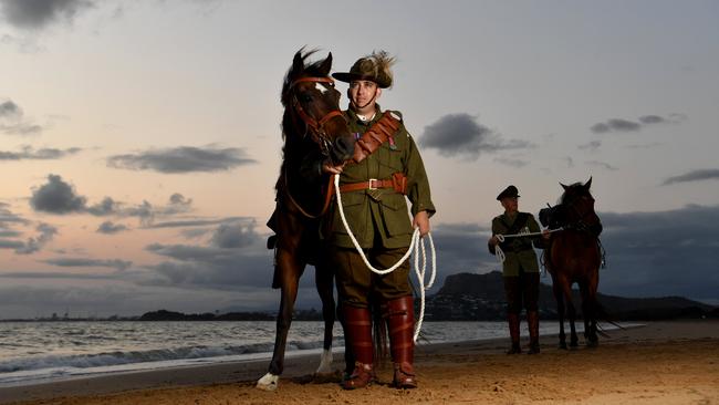 Veteran and 27th Light Horse Regiment Incorporated president Jason Mengel and his dad Vietnam Veteran Lester Mengel with Soks and Chaser at Rowes Bay at dawn are set for Remembrance Day. Picture: Evan Morgan