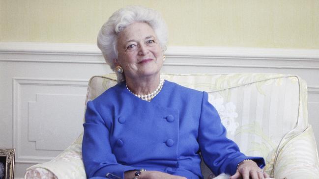 FILE - In this 1990 file photo, first lady Barbara Bush poses with her dog Millie in Washington. A family spokesman said Tuesday, April 17, 2018, that former first lady Barbara Bush has died at the age of 92. (AP Photo/Doug Mills, File)