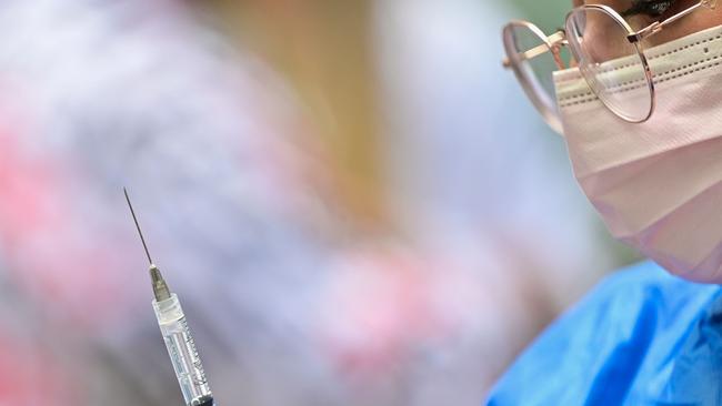 A health worker prepares a dose of the Pfizer-BioNTech vaccine against COVID-19 to be applied to children from 5 to 11 years old, in Mexico City, on June 27, 2022. (Photo by Pedro PARDO / AFP)