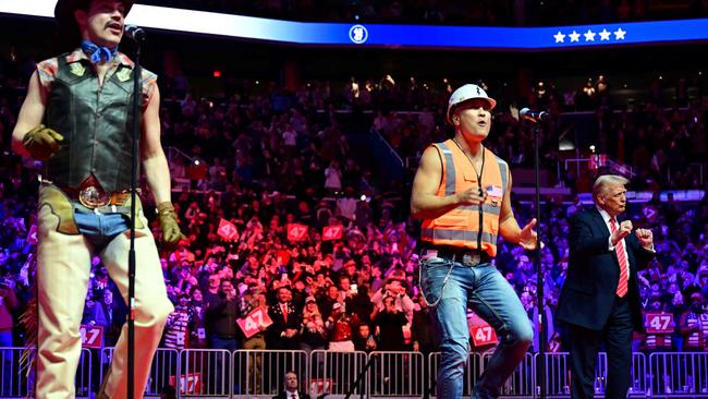 US President-elect Donald Trump dances as the Village People perform at a MAGA victory rally at Capital One Arena in Washington, DC, on January 19, 2025, one day ahead of his inauguration ceremony. (Photo by Jim WATSON / AFP)