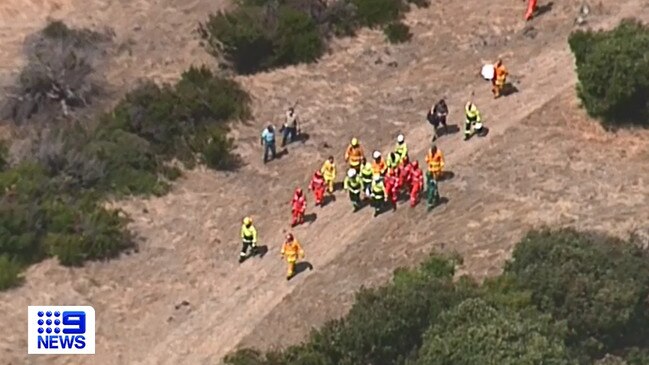 Rescue crews take the injured man to the helicopter. Picture: Nine News,