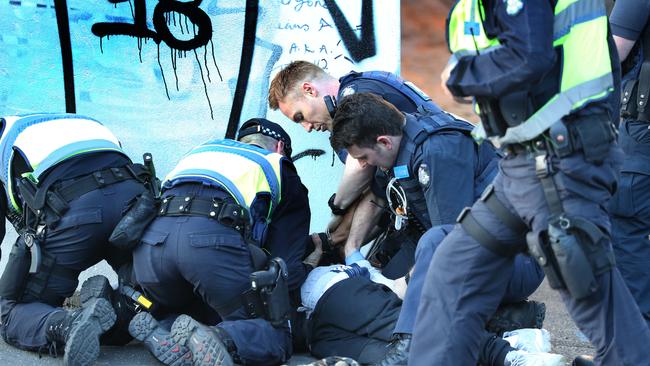 Police arrest one of the offenders following an attempted aggravated burglary at the Carlton commission flats. Picture: David Caird