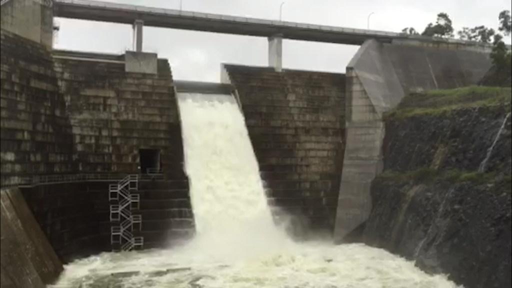 Hinze Dam overflows following torrential rains