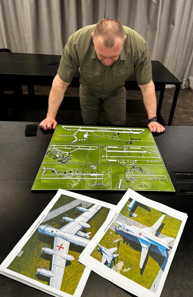 Head of Ukraine‘s Security Service Vasyl Malyuk looking at a map showing a Russian military aircraft base. Picture: AFP.