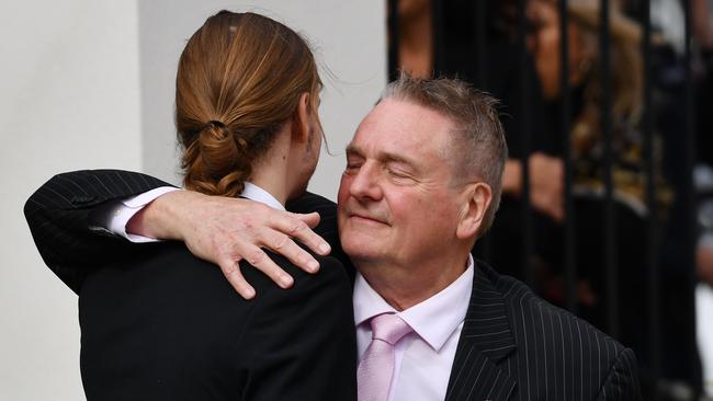 Joanne Shanahan’s son Nick and husband Peter embrace outside the funeral service. Picture: David Mariuz/AAP