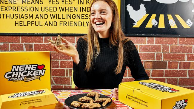 Caitlyn McMahon with a piece of 23 karat gold chicken from Nene Chicken in Casuarina. Picture: Griffin Simm