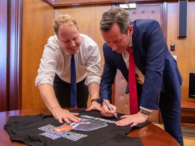 West Australian Premier Mark McGowan signs the T-shirt with state Labor MP David Michael.