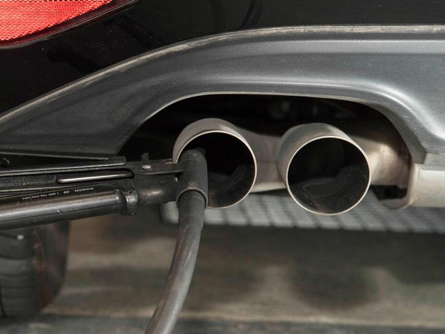 (FILES) In this file photo taken on August 7, 2017 a hose for an emission test is fixed in the exhaust pipe of a Volkswagen Golf 2,0 litre diesel car at the Technical Inspection Agency in Ludwigsburg, southwestern Germany. The German government on January 29, 2018 strongly condemned revelations that three carmakers had tested the effects of diesel fumes on monkeys and humans, adding that it had asked BMW, Volkswagen and Daimler to explain themselves. / AFP PHOTO / THOMAS KIENZLE