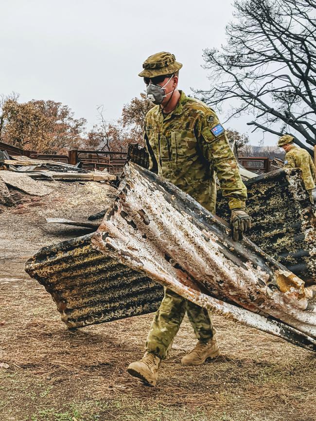 Soldiers clearing remains of a shearing shed. Picture: ADF