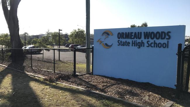 Students outside Ormeau Woods State High School the morning after a student died