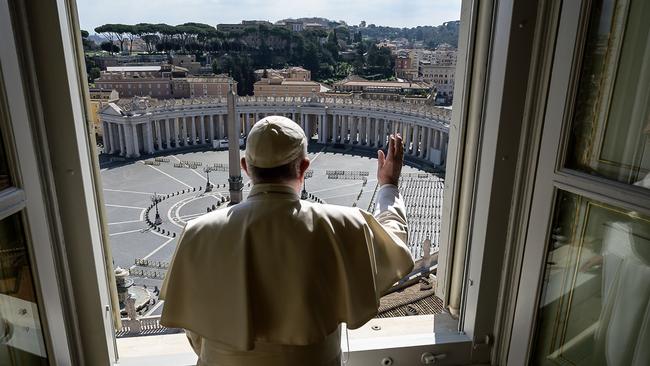 Pope Francis blesses an empty St Peter’s Square at the Vatican as his Angelus prayer is live-streamed at the weekend. Picture: AFP