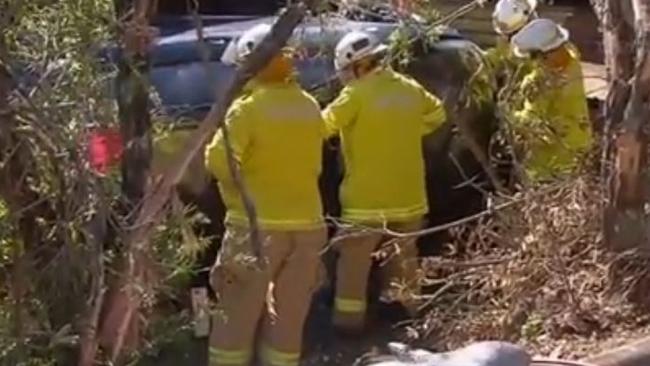 Fire crews attempt to cut Tara free from the wreckage at Molendinar. Photo: Channel 10