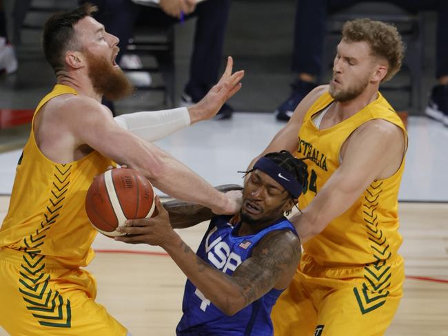 LAS VEGAS, NEVADA - JULY 12:  Bradley Beal #4 of the United States drives into Aron Baynes #12 of the Australia Boomers as Jock Landale #34 of the Boomers defends during an exhibition game at Michelob Ultra Arena ahead of the Tokyo Olympic Games on July 12, 2021 in Las Vegas, Nevada.  (Photo by Ethan Miller/Getty Images)