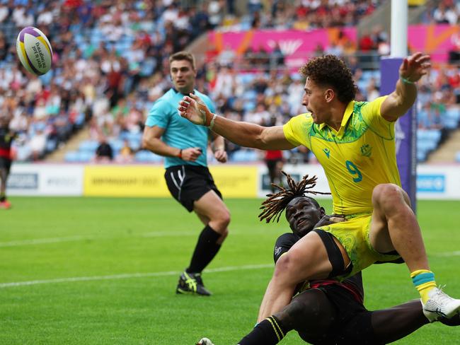 Uganda’s Aaron Ofoyrwothtackles Mark Nawaqanitawase in a thrilling Sevens clash. Picture: Richard Heathcote/Getty Images