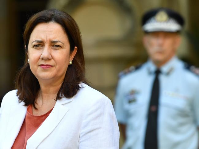 Queensland Premier Annastacia Palaszczuk (left) is seen during a press conference at Queensland Parliament House in Brisbane, Monday, March 30, 2020. Premier Palaszczuk announced that Queensland had 33 more cases of coronavirus (COVID-19), taking the state's overall number to 689 cases. (AAP Image/Darren England) NO ARCHIVING