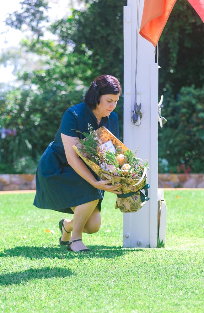 Chief Minister Natasha Fyles lays a floral tribute on the Government House lawn to mark the passing of Queen Elizabeth II. Picture: Glenn Campbell.