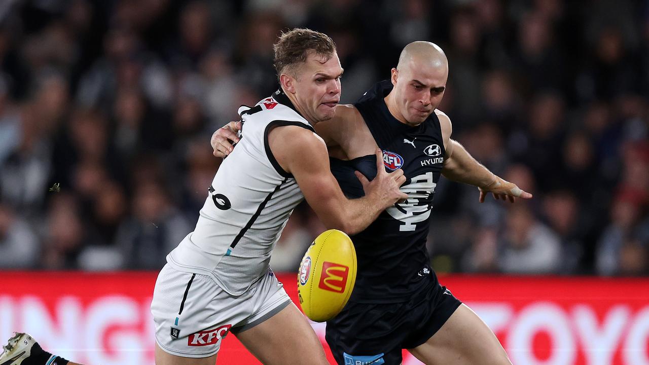 Alex Cincotta of the Blues and Dan Houston of the Power in action. Picture: Mark Stewart